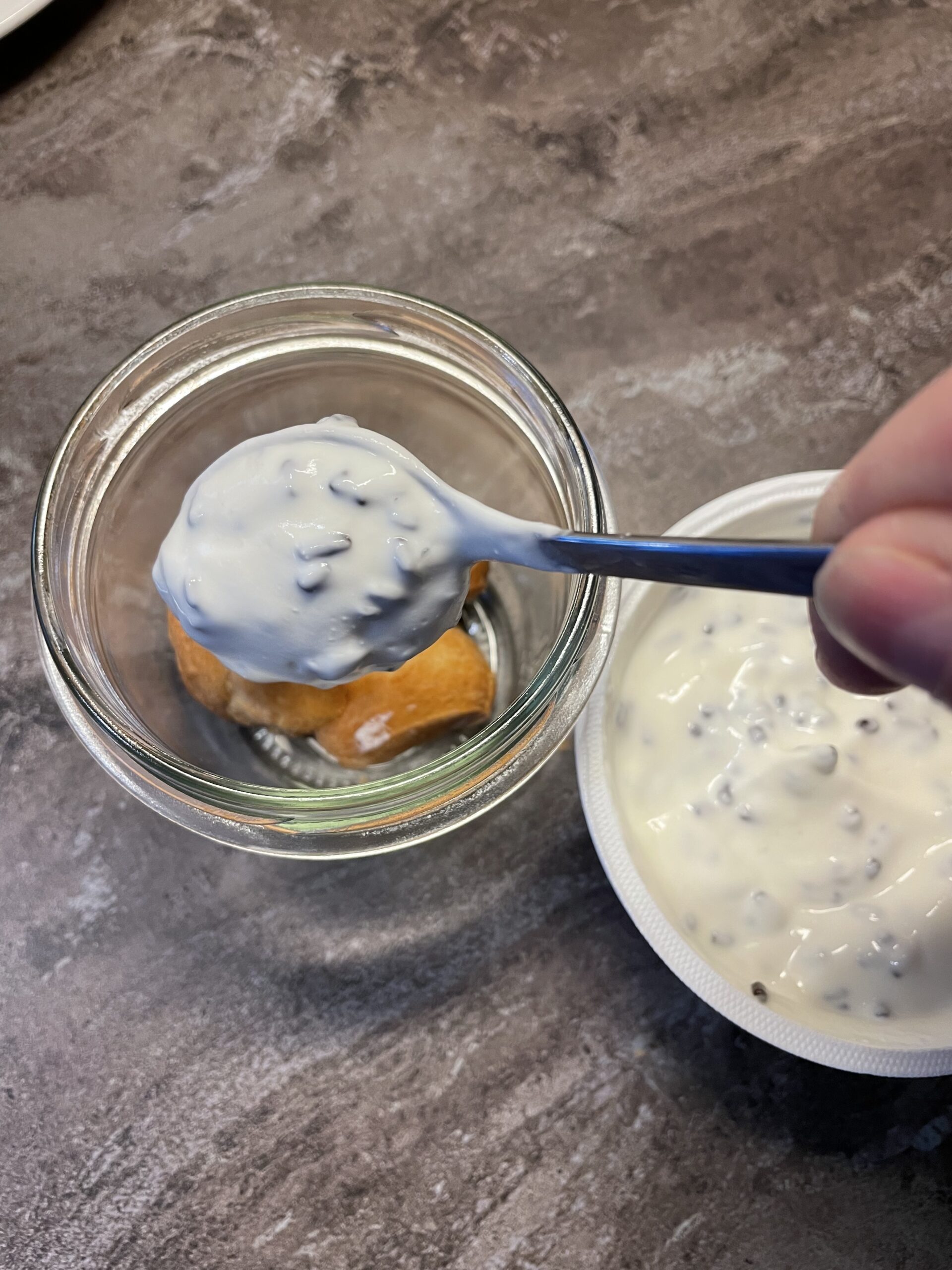 Bild zum Schritt 16 für das Bastel- und DIY-Abenteuer für Kinder: 'Nun füllt ihr einige Teelöffel Joghurt  in das Marmeladenglas...'