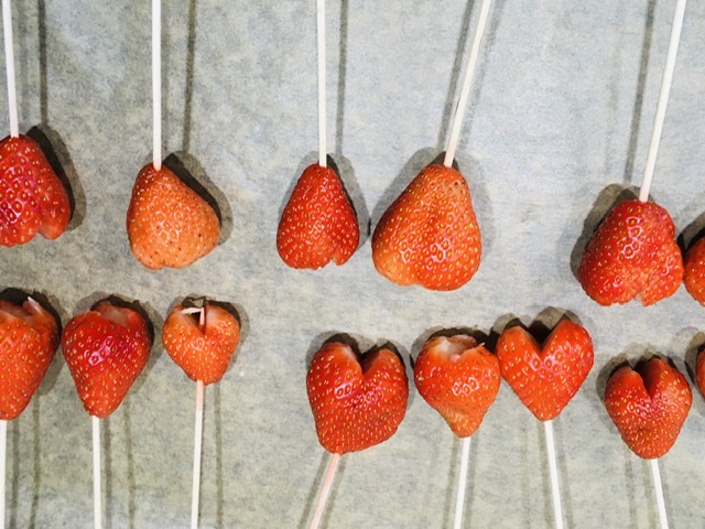 Bild zum Schritt 6 für das Bastel- und DIY-Abenteuer für Kinder: 'Die Erdbeer-Spieße auf ein Backpapier legen.'